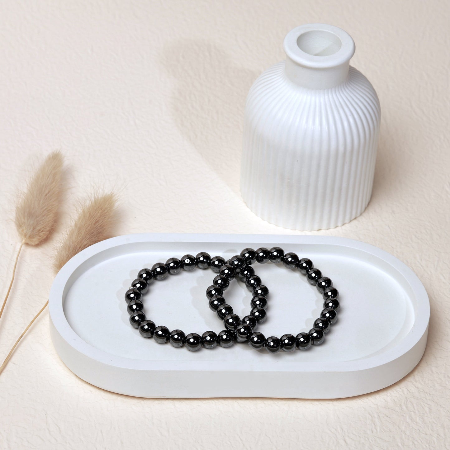 Lifestyle shot of Hematite bracelets, featuring the sleek, metallic silver hues of the crystals.