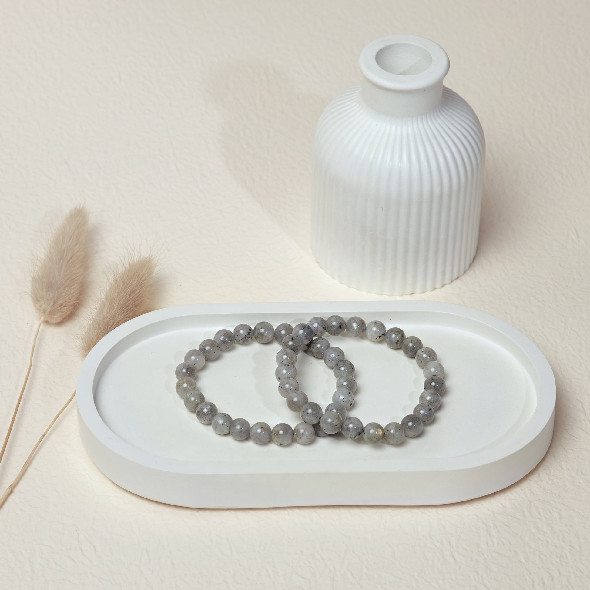 Lifestyle shot of Labradorite bracelets, featuring the iridescent grey hues of the crystals.