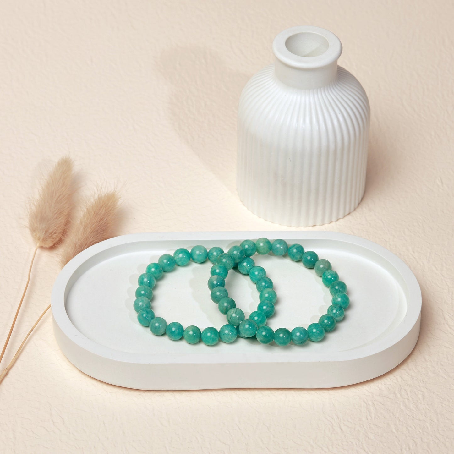 Lifestyle shot of Amazonite bracelets, featuring the soothing green-blue hues of the crystals.