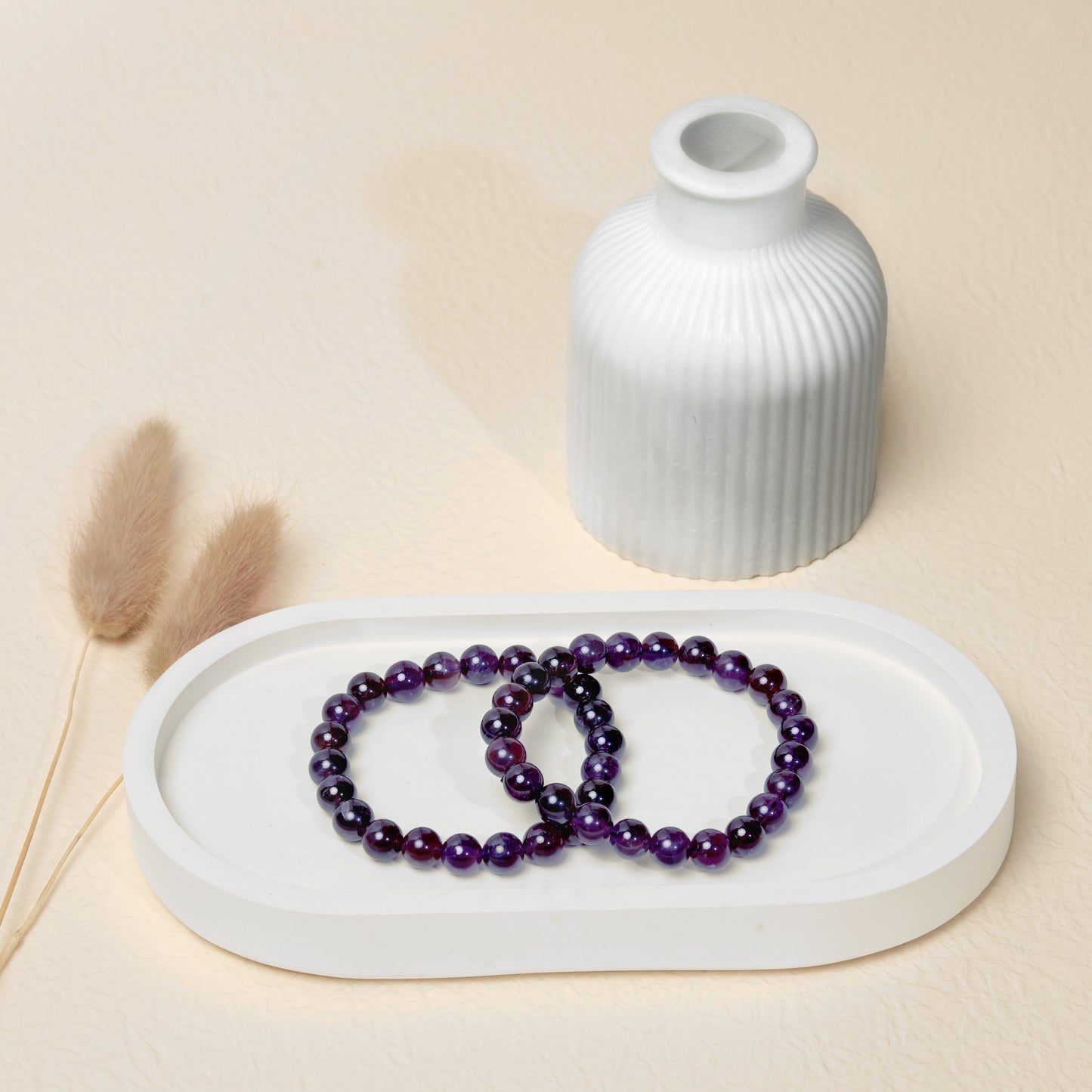 Lifestyle shot of Amethyst bracelets, featuring the deep purple hues of the crystals.