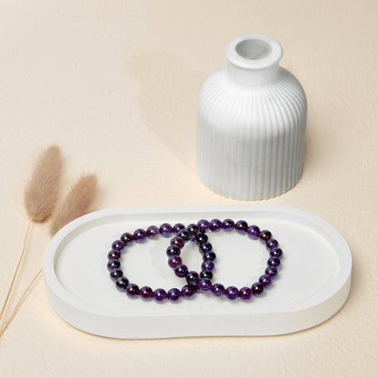Lifestyle shot of Amethyst bracelets, featuring the deep purple hues of the crystals.