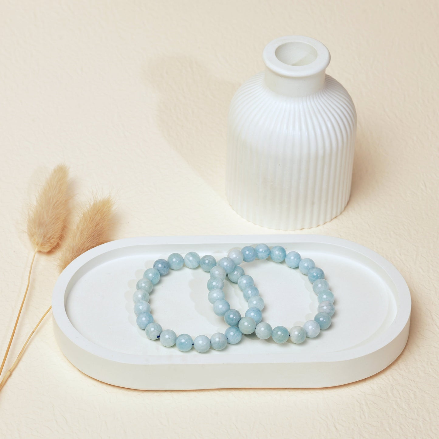 Lifestyle shot of Aquamarine bracelets, featuring the serene soft blue hues of the crystals.