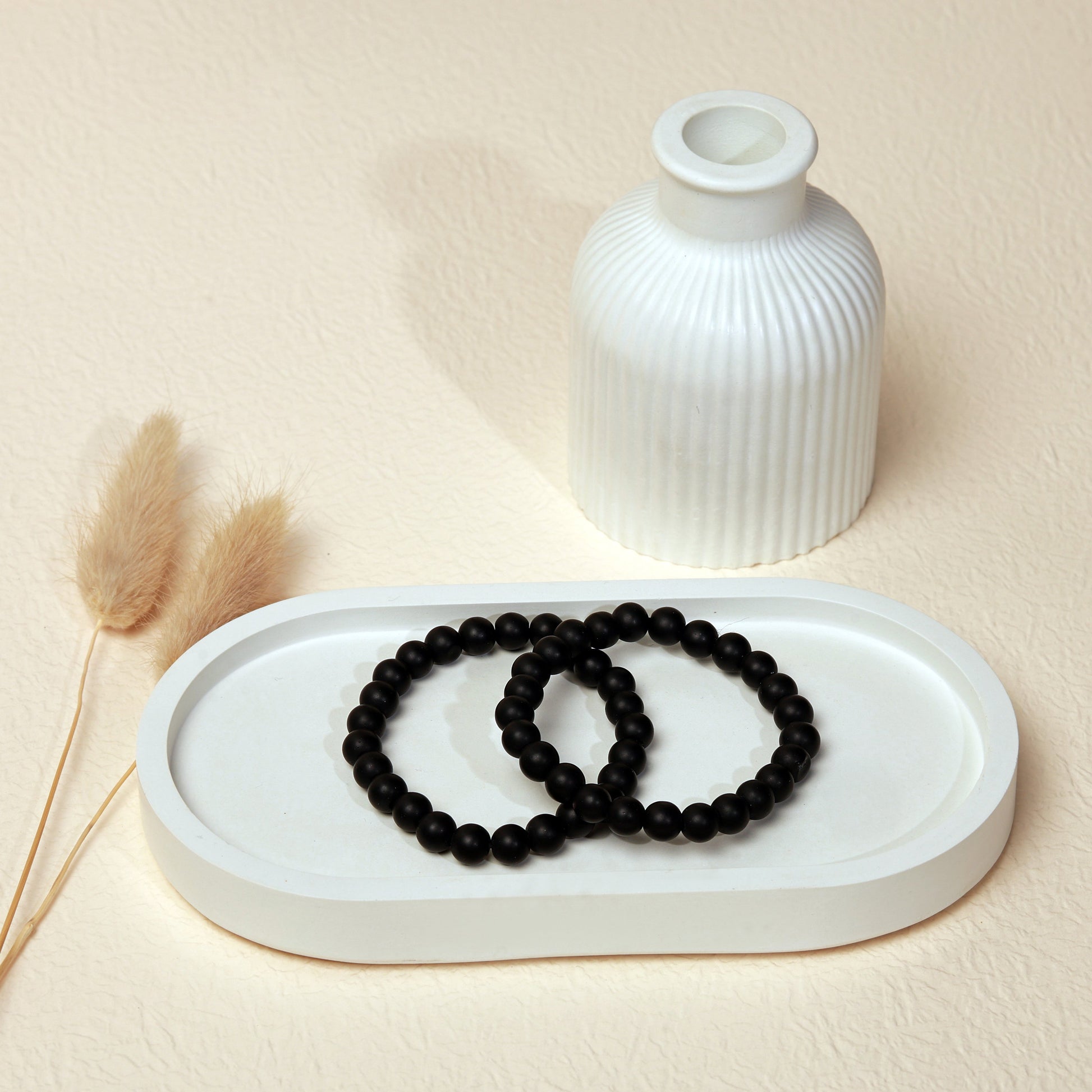 Lifestyle shot of Black Onyx bracelets, featuring the sleek, matte black hues of the crystals.