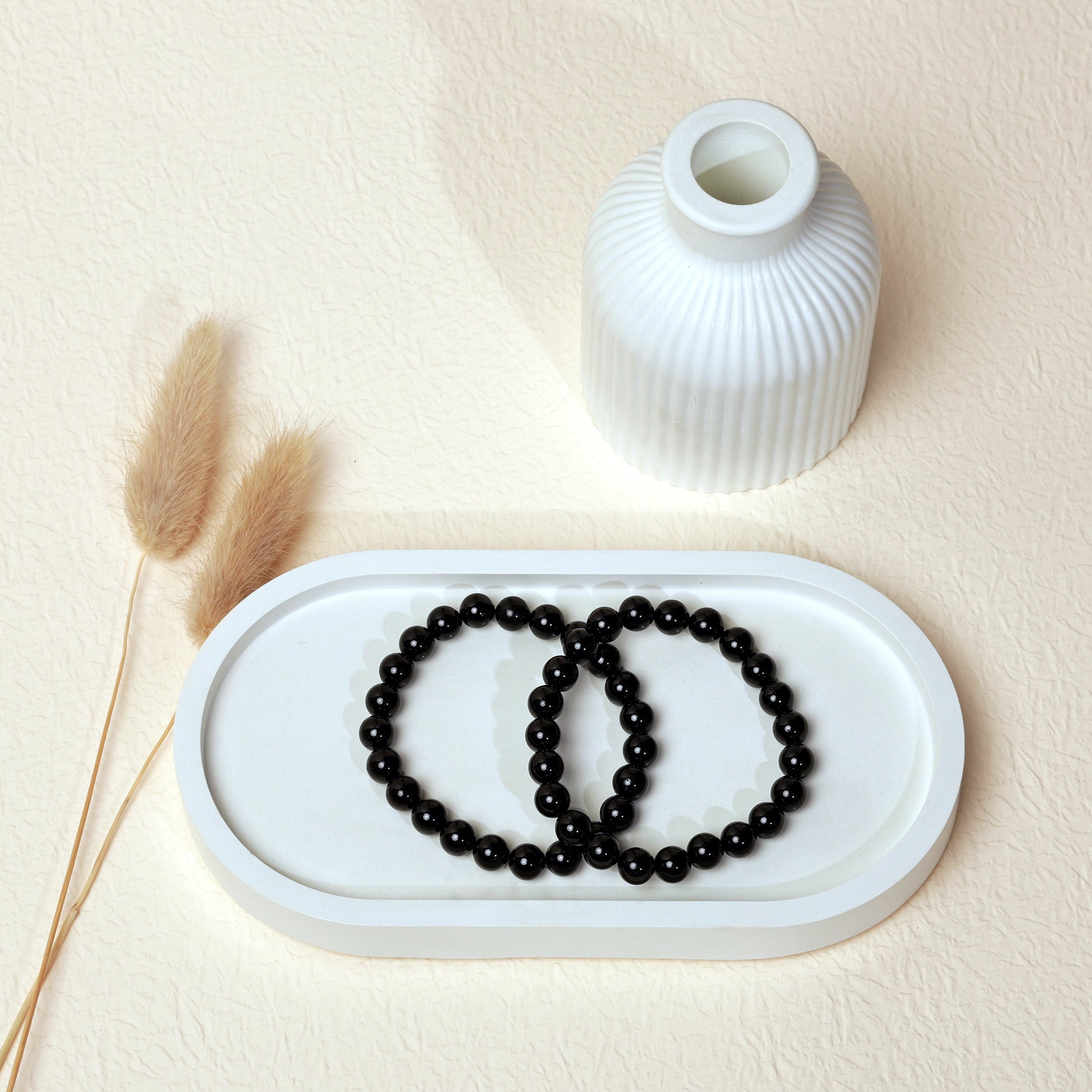 Lifestyle shot of Black Tourmaline bracelets, featuring the striking, deep black hues of the crystals.