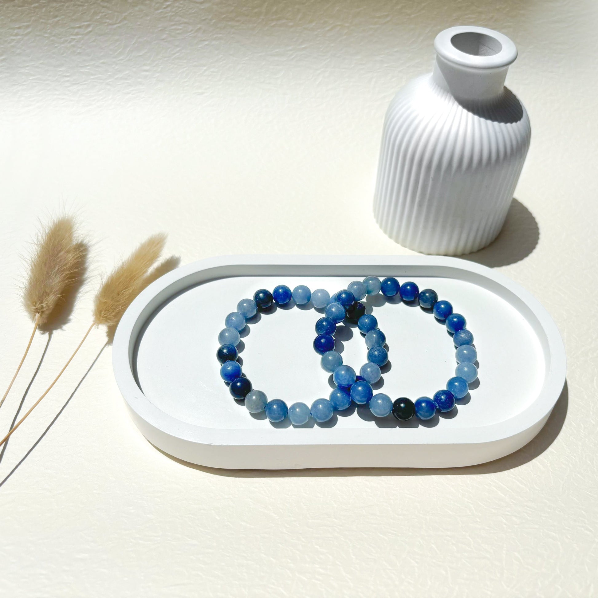 Lifestyle shot of Blue Aventurine bracelets, featuring the soothing blue hues of the crystals.