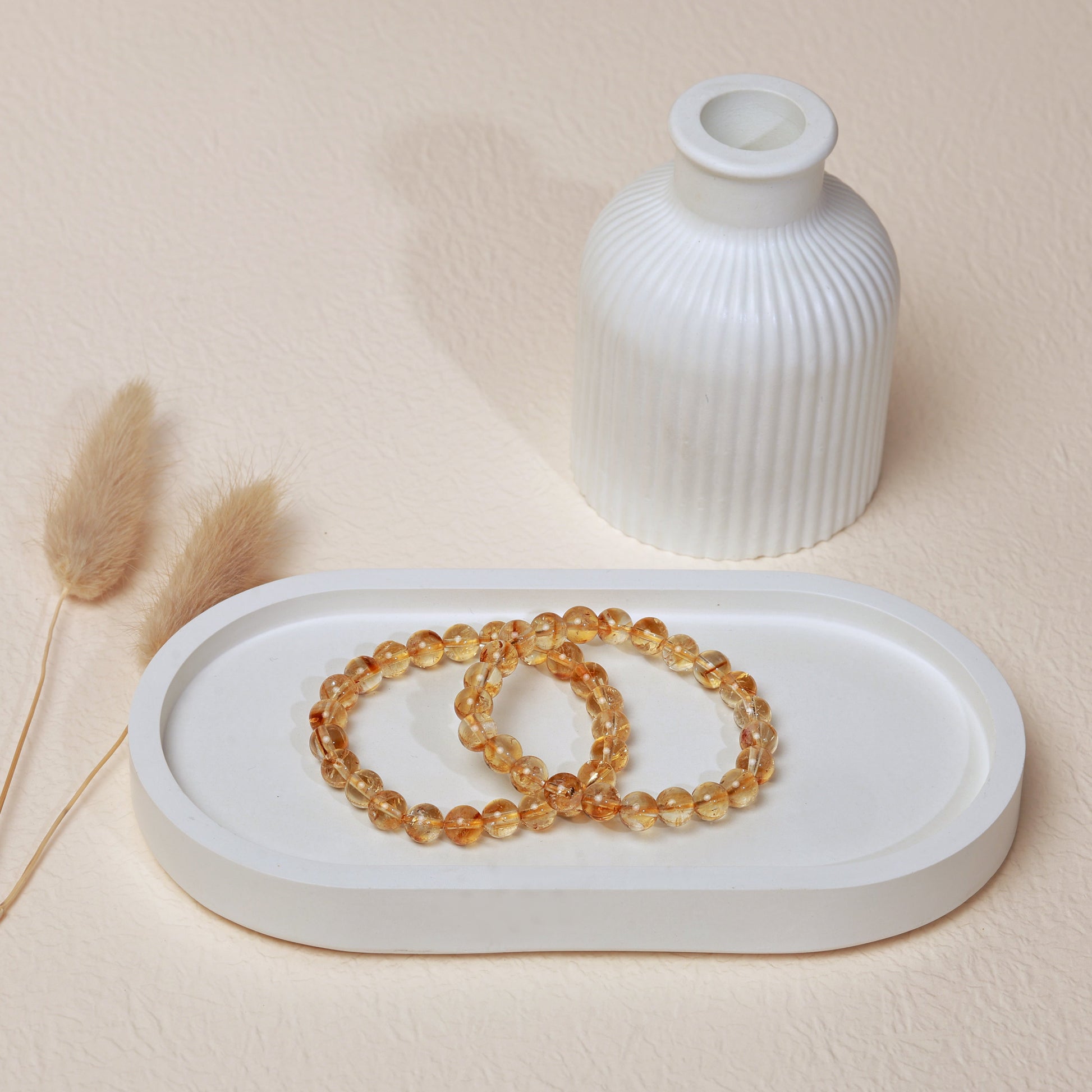 Lifestyle shot of Citrine bracelets, featuring the radiant warm golden hues of the crystals.