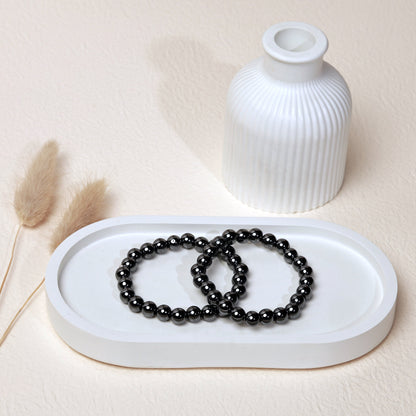 Lifestyle shot of Hematite bracelets, featuring the sleek, metallic silver hues of the crystals.