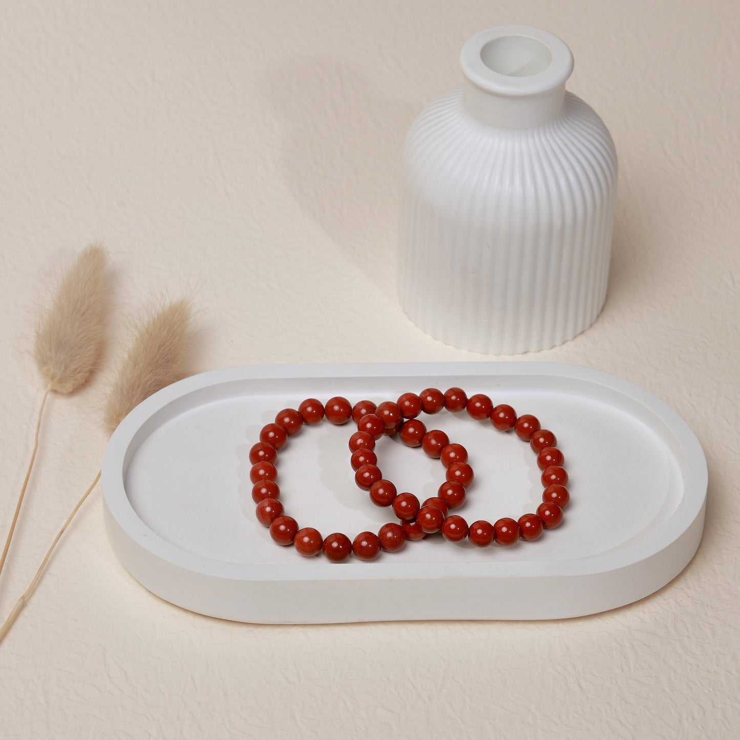 Lifestyle shot of Red Jasper bracelets, featuring the warm, earthy red hues of the crystals.