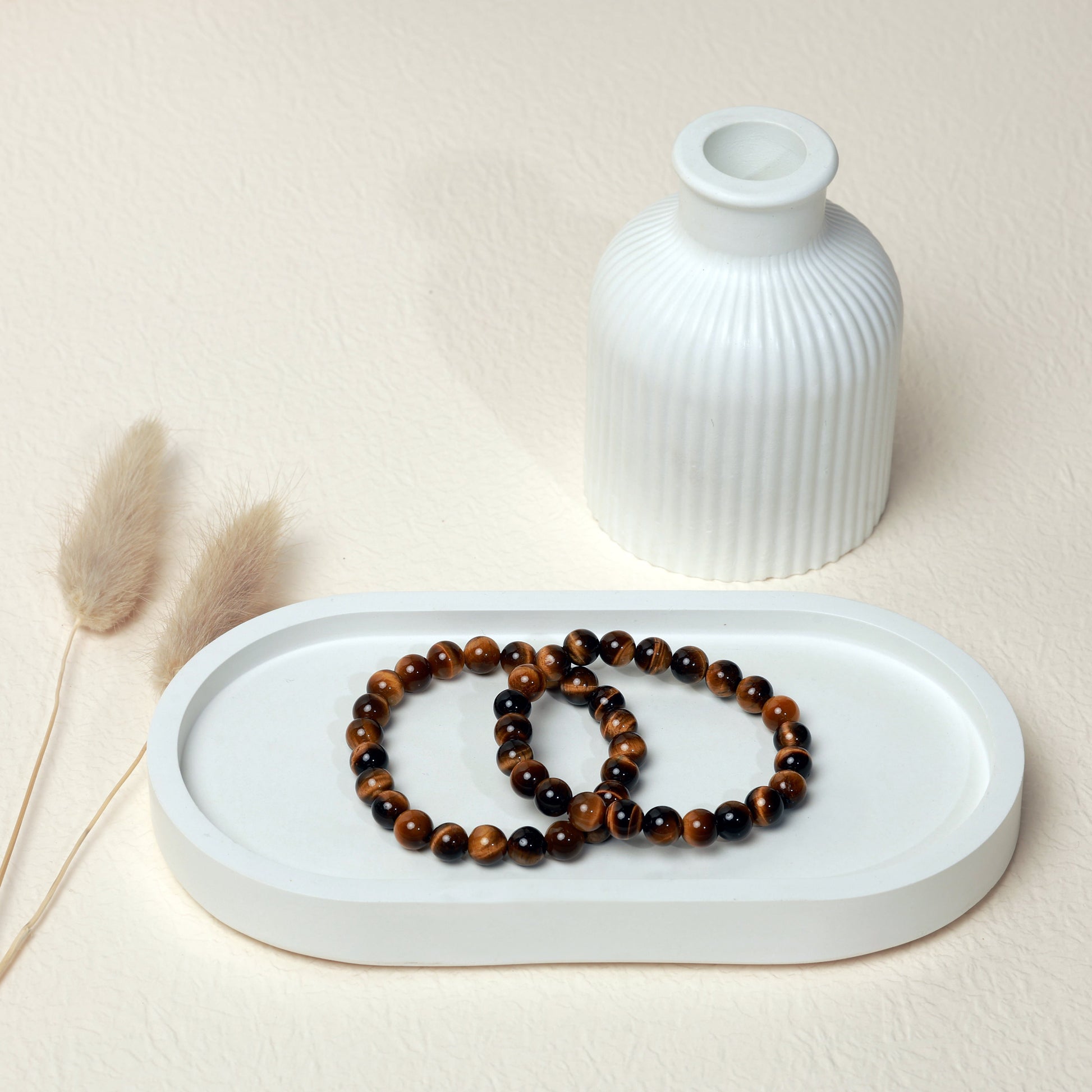 Lifestyle shot of Tigers Eye bracelets, featuring the rich golden and brown hues of the crystals.