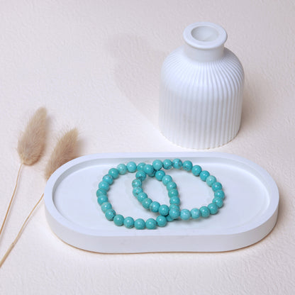 Lifestyle shot of Turquoise bracelets, featuring the vibrant blue-green hues of the crystals.